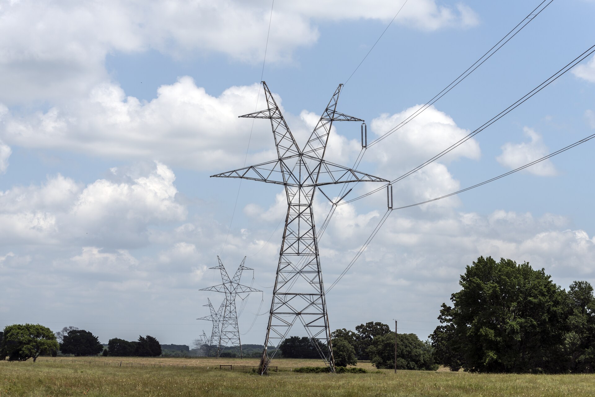 Transmission towers crossing open farmland in Van Zandt County, Texas